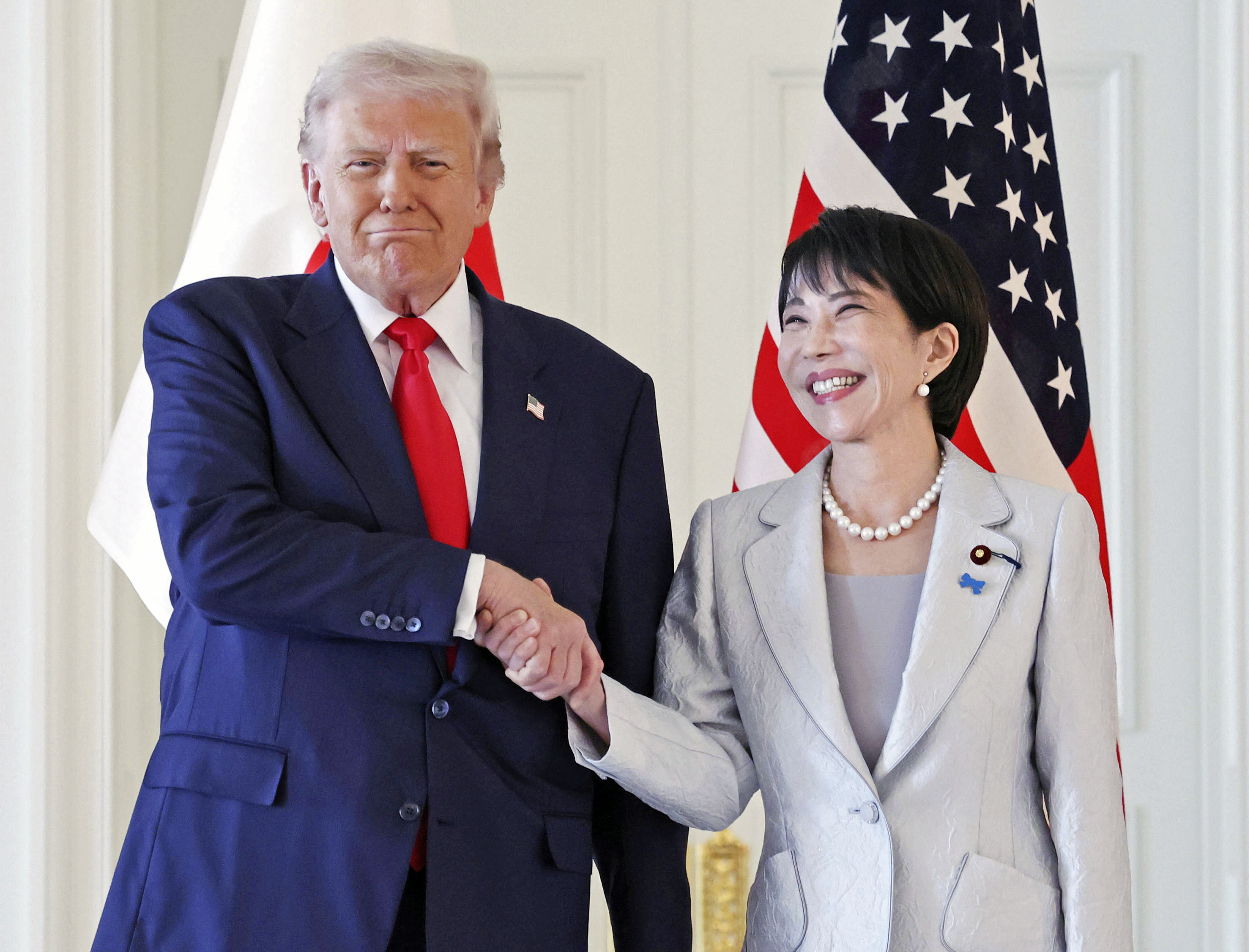 President Donald Trump, left, and Japanese Prime Minister Sanae Takaichi shake hands before their summit talk at Akasaka Palace in Tokyo, on Tuesday.